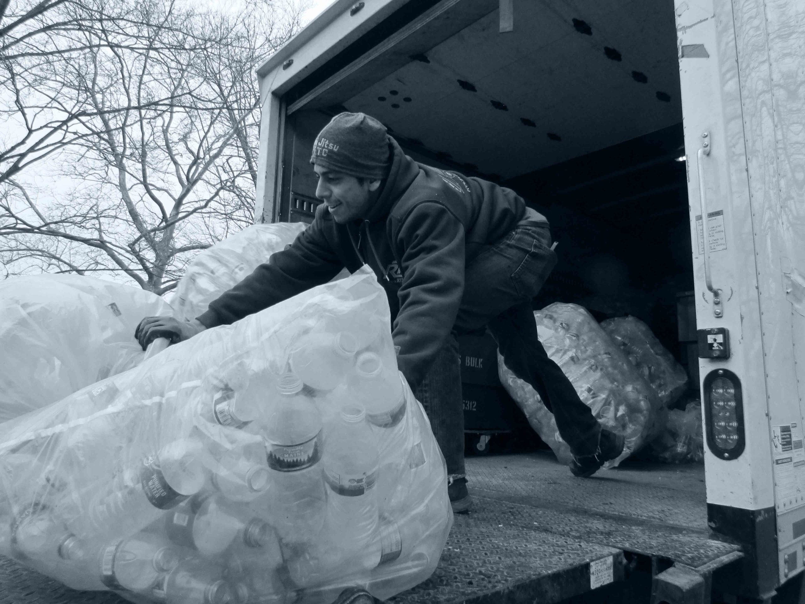 Man recycling plastic water bottles