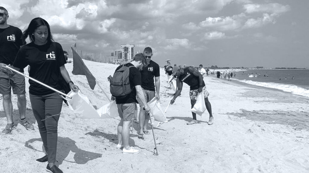 RTS employees cleaning up a beach